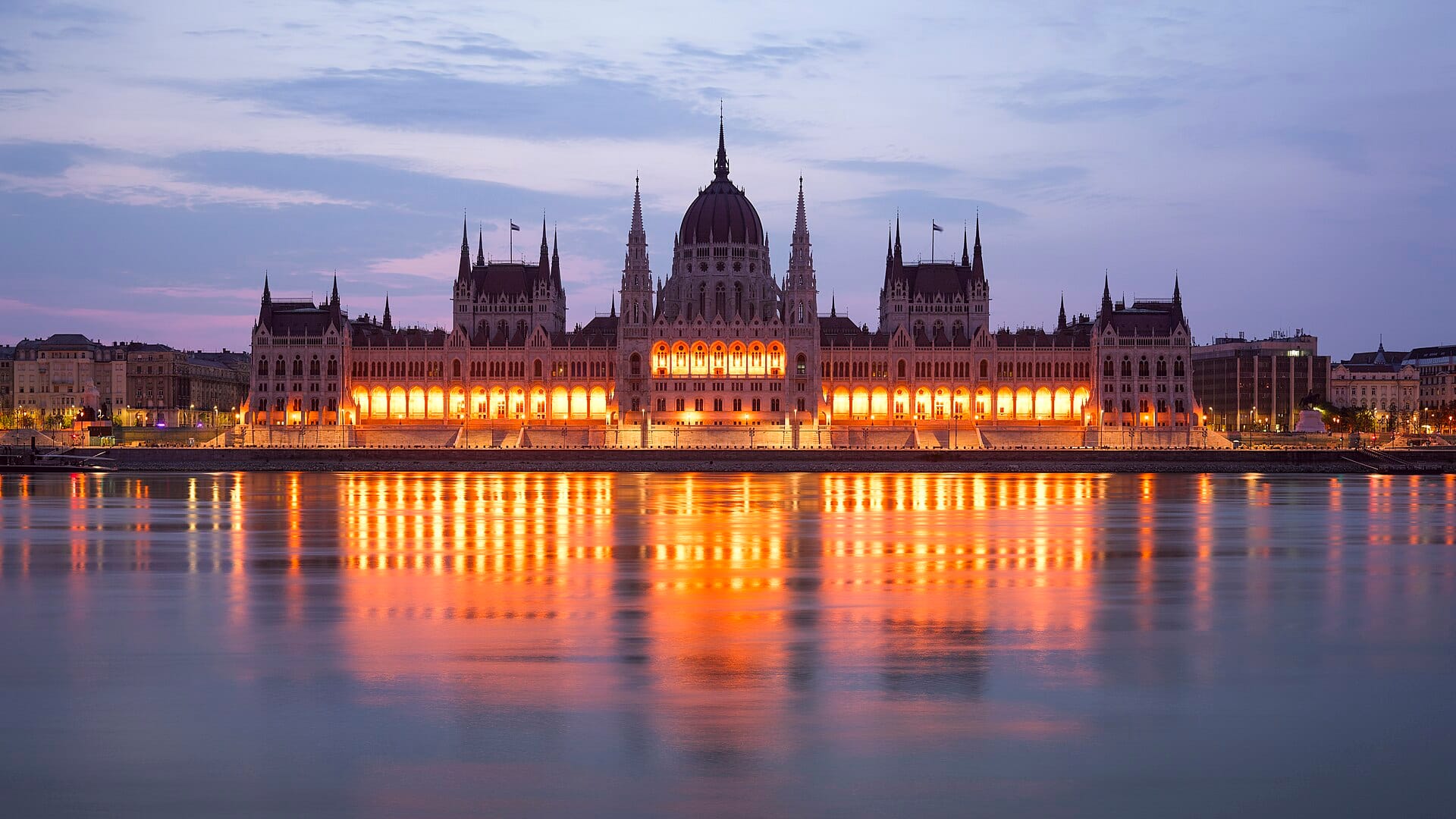 The Hungarian Parliament glowing over the Danube at dusk