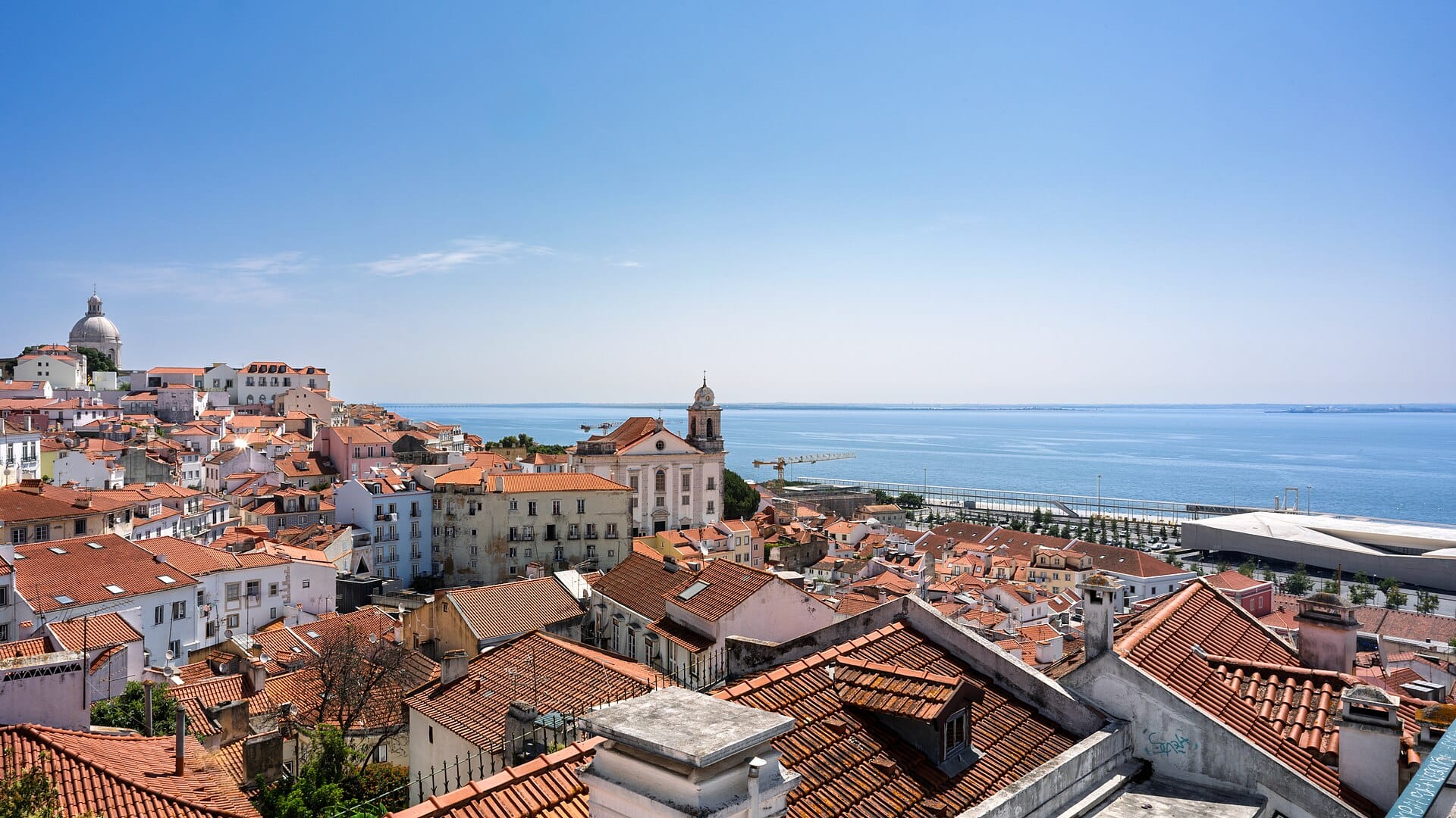 Terracotta rooftops of Alfama running down to the Tagus